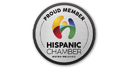 Circular badge displaying Proud Member Hispanic Chamber Metro Orlando with a colorful abstract H logo in the center.
